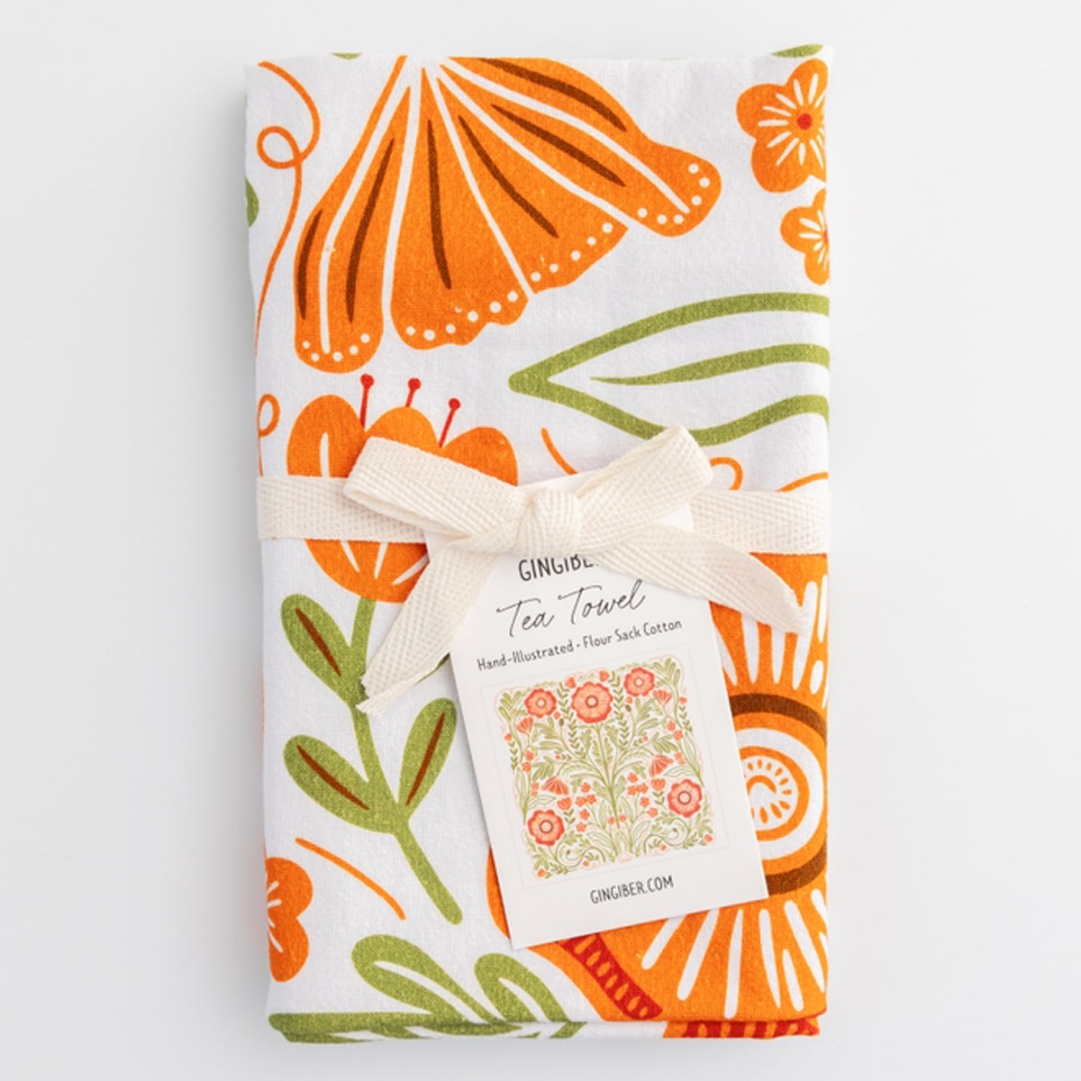 Close up of Gingiber Poppy Tea Towel (1 pc) shown folded with Gingiber linen bow and tag