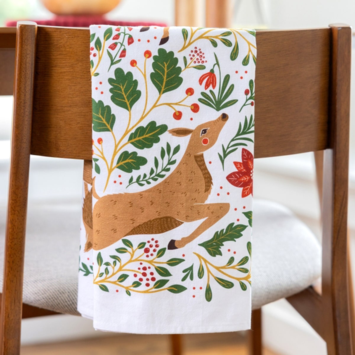 Gingiber Christmas Forest Tea Towel (1 pc) shown folded over chair