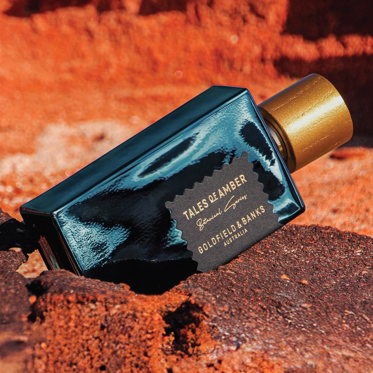 Goldfield & Banks Tales of Amber Extrait de Parfum (100 ml) on a red rock background