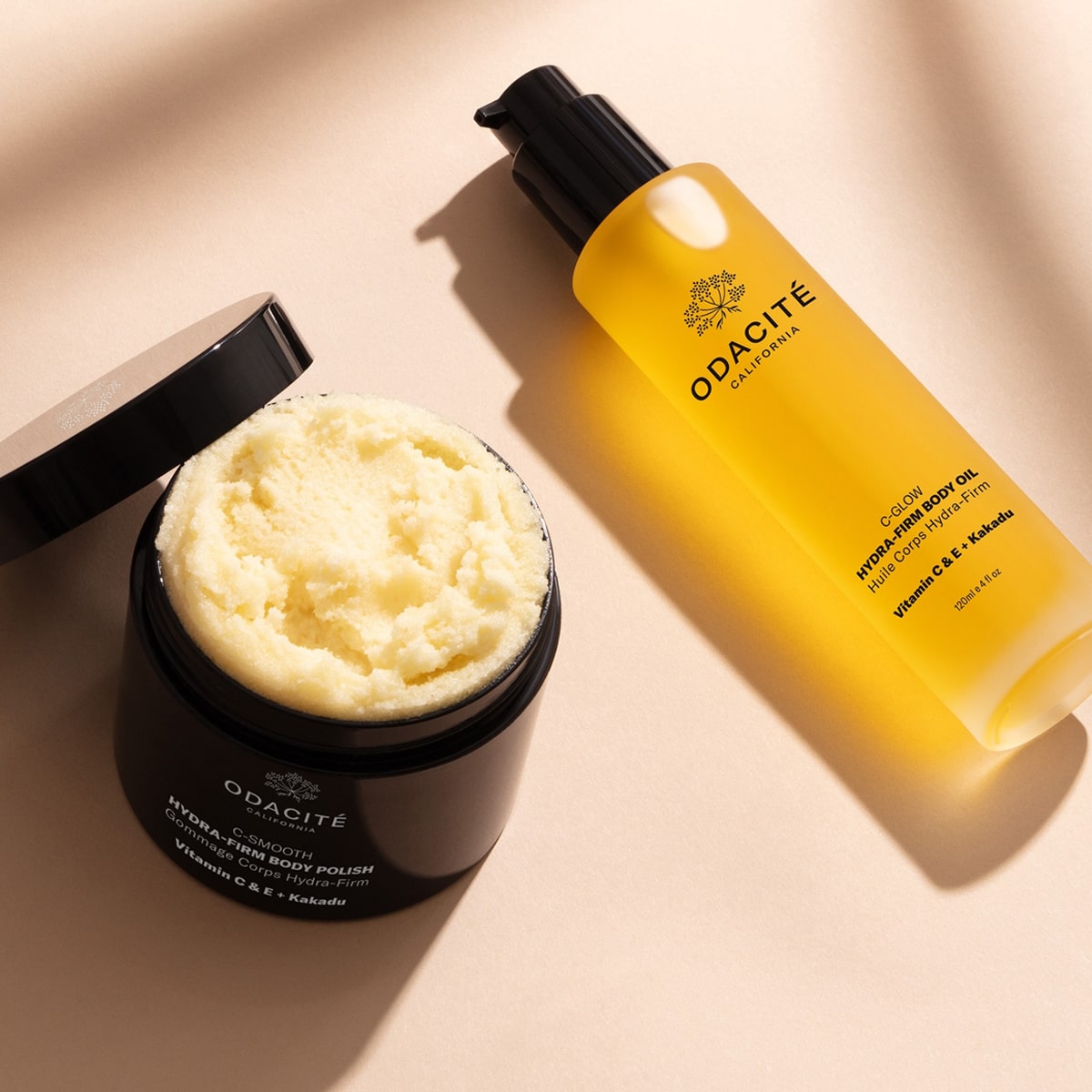 Odacite Smooth + Glow Vitamin C Body Essentials Set (2 pc) - products shown on beige background. 