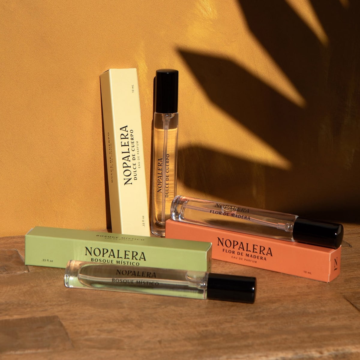 Lifestyle shot of Nopalera Travel Fragrance Trio (3 x 10 ml) boxes and bottles shown