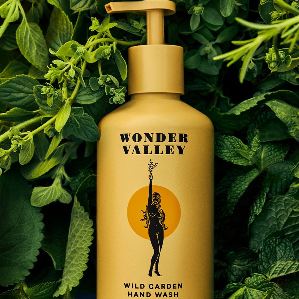 Wonder Valley Wild Garden Hand Wash (300 ml) surrounded by mint leaves