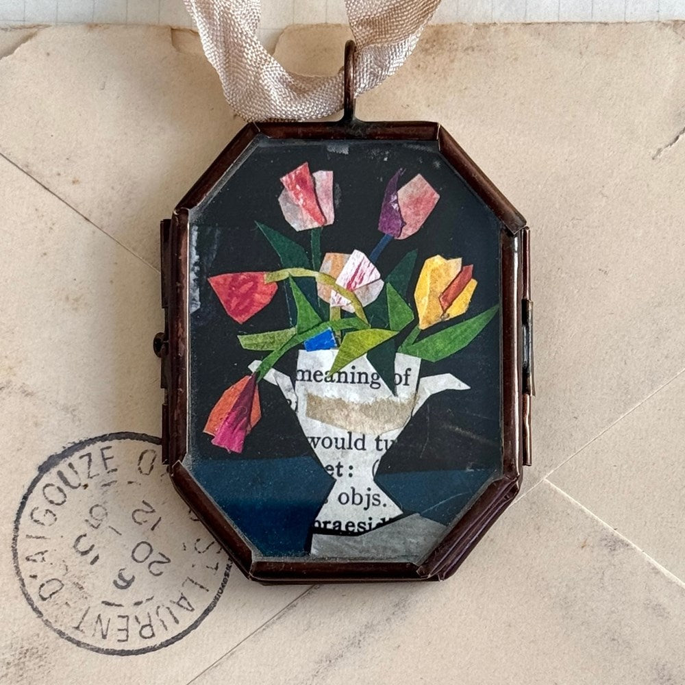 Maris Mirum Small Locket - Tulips in Urn (1 pc) on an aged envelope background with a stamp