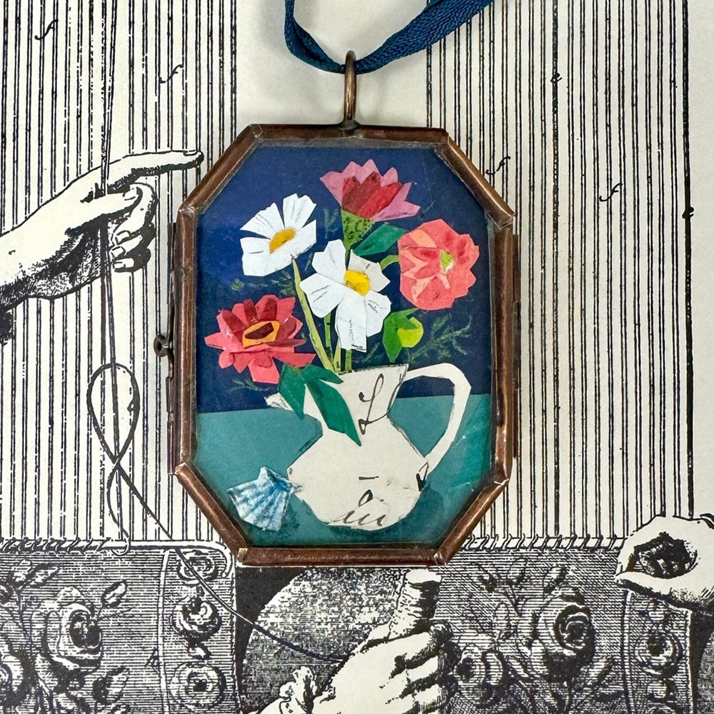Maris Mirum Small Locket - Zinnia & Shell (1 pc) with black and white illustration of flowers on a striped background