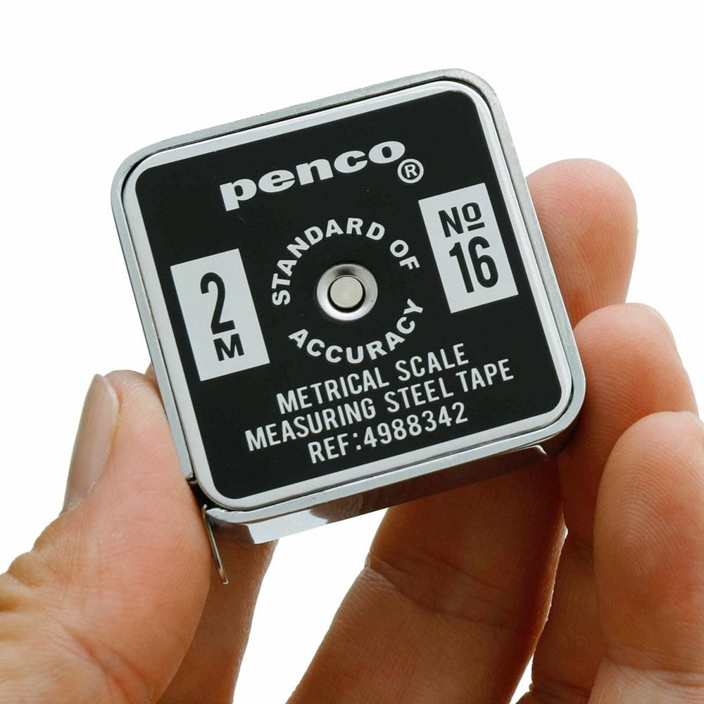Penco Tape Measure (1 pc) - product shown being held by hands. 