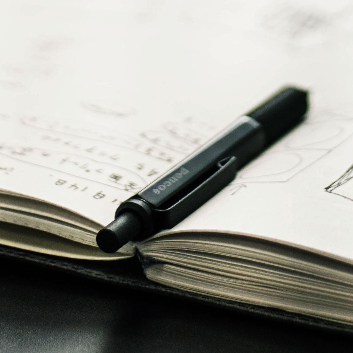 Penco Drafting Pencil - Black (1 pc) - Product shown in between pages. 