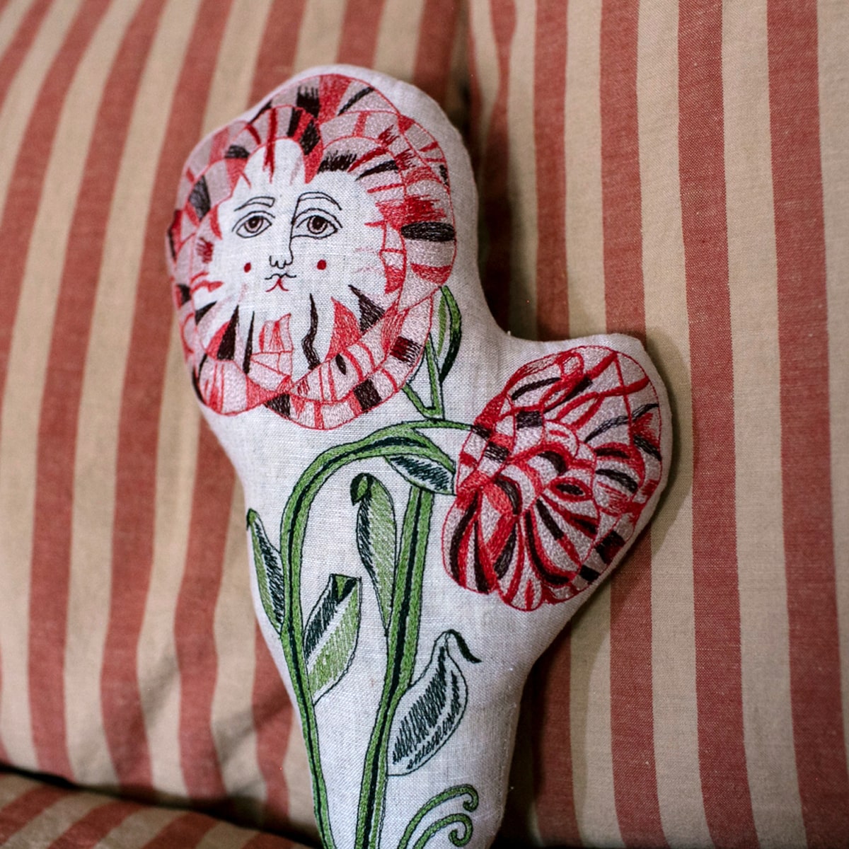 Skippy Cotton Poppies Pillow (1 pc) on a striped fabric background