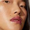 Close-up of model wearing Minori Lip Gloss - Juneberry
