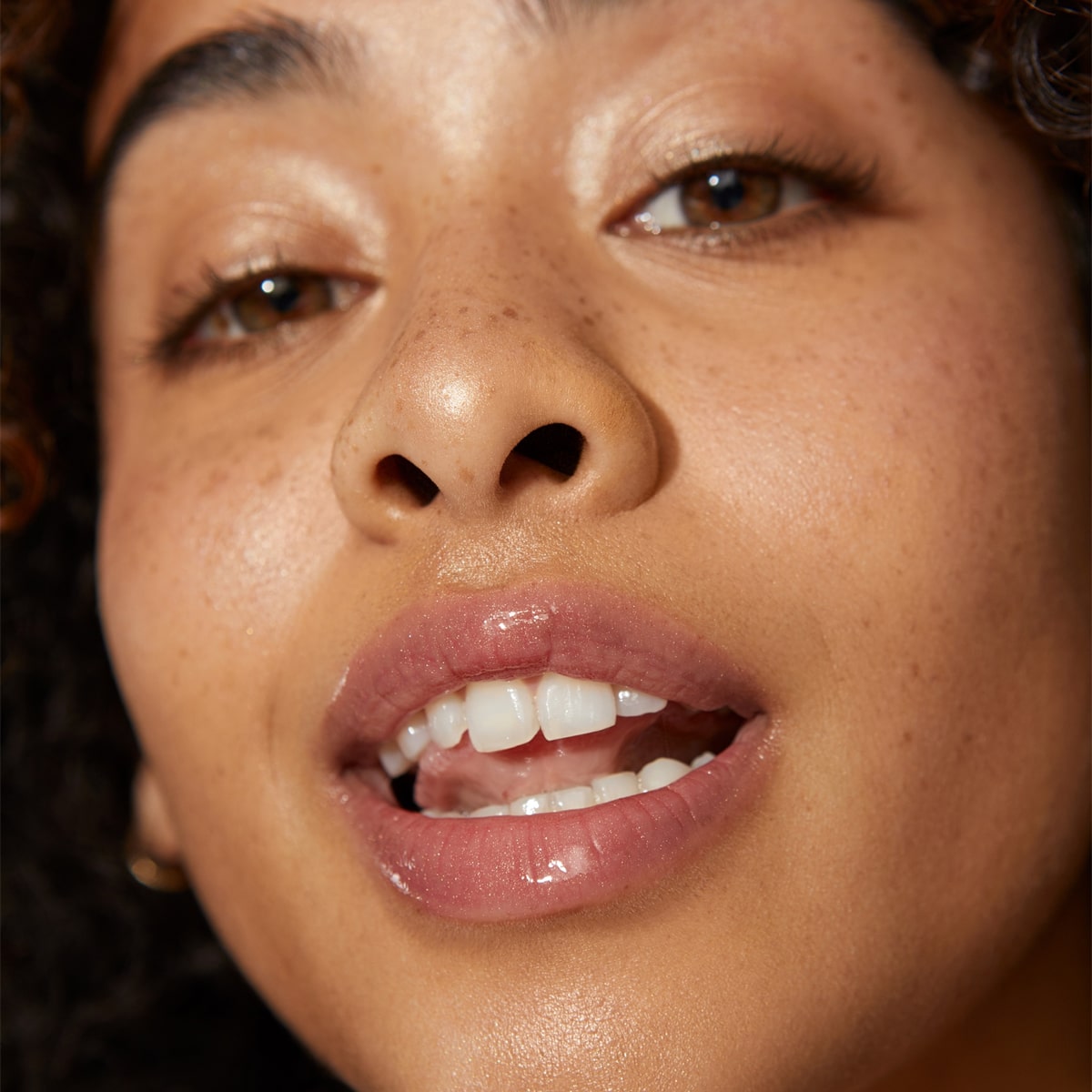 Close up of model wearing Minori Lip Gloss - Blossom