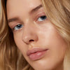 Close up of model with light to medium complexion wearing Minori Lip Serum - Dream