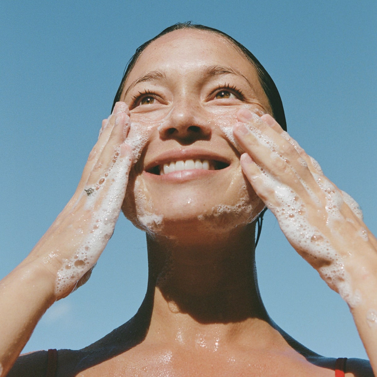 Ursa Major Fantastic Face Wash (4 oz) - model shown using product on face. 