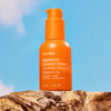 Ursa Major Brighten Up Vitamin C Serum (1 oz) - product shown on bright blue background and wood. 