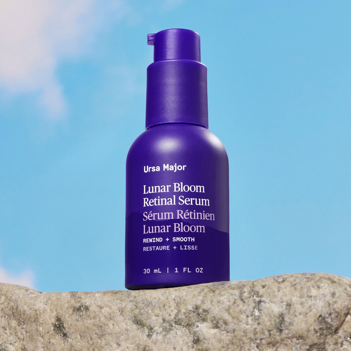 Ursa Major Lunar Bloom Retinal Serum (1 oz) - product shown on bright blue background and stone. 