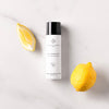 Essential Parfums Nice Bergamote Hair & Body Mist (100 ml) - product shown next to lemons. 