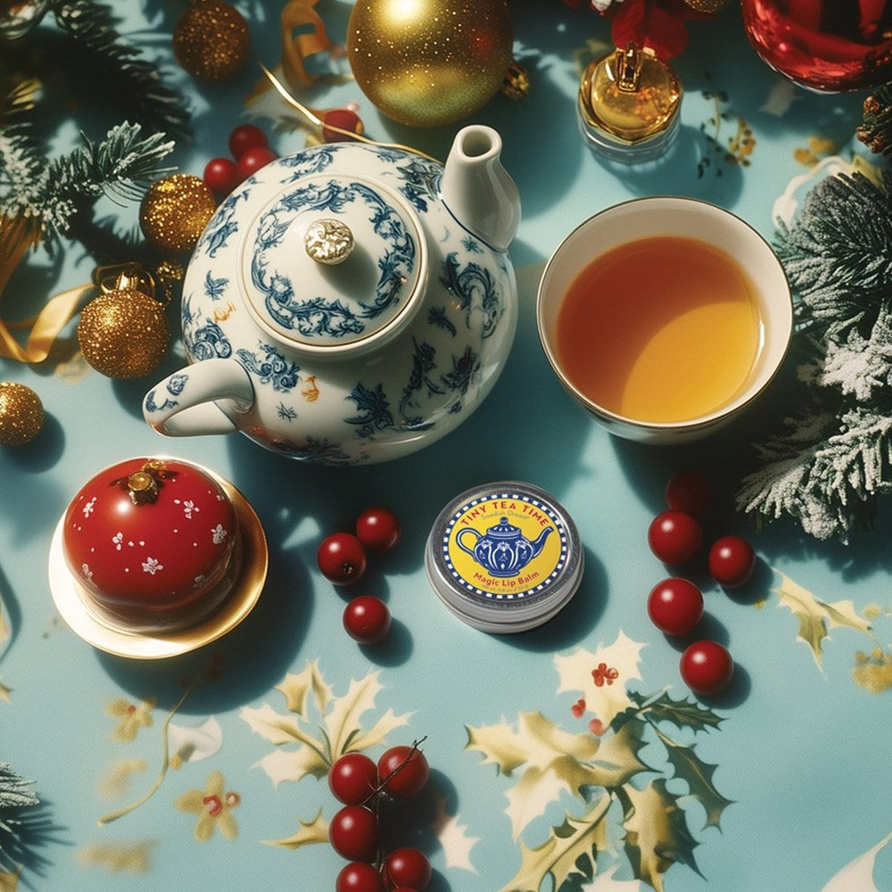 Tea set with teapot, cup, and cookies on a festive table with Christmas decorations showng Kalastyle Soap Co. Swedish Dream Tiny Tea Time Lip Balm (22 g)