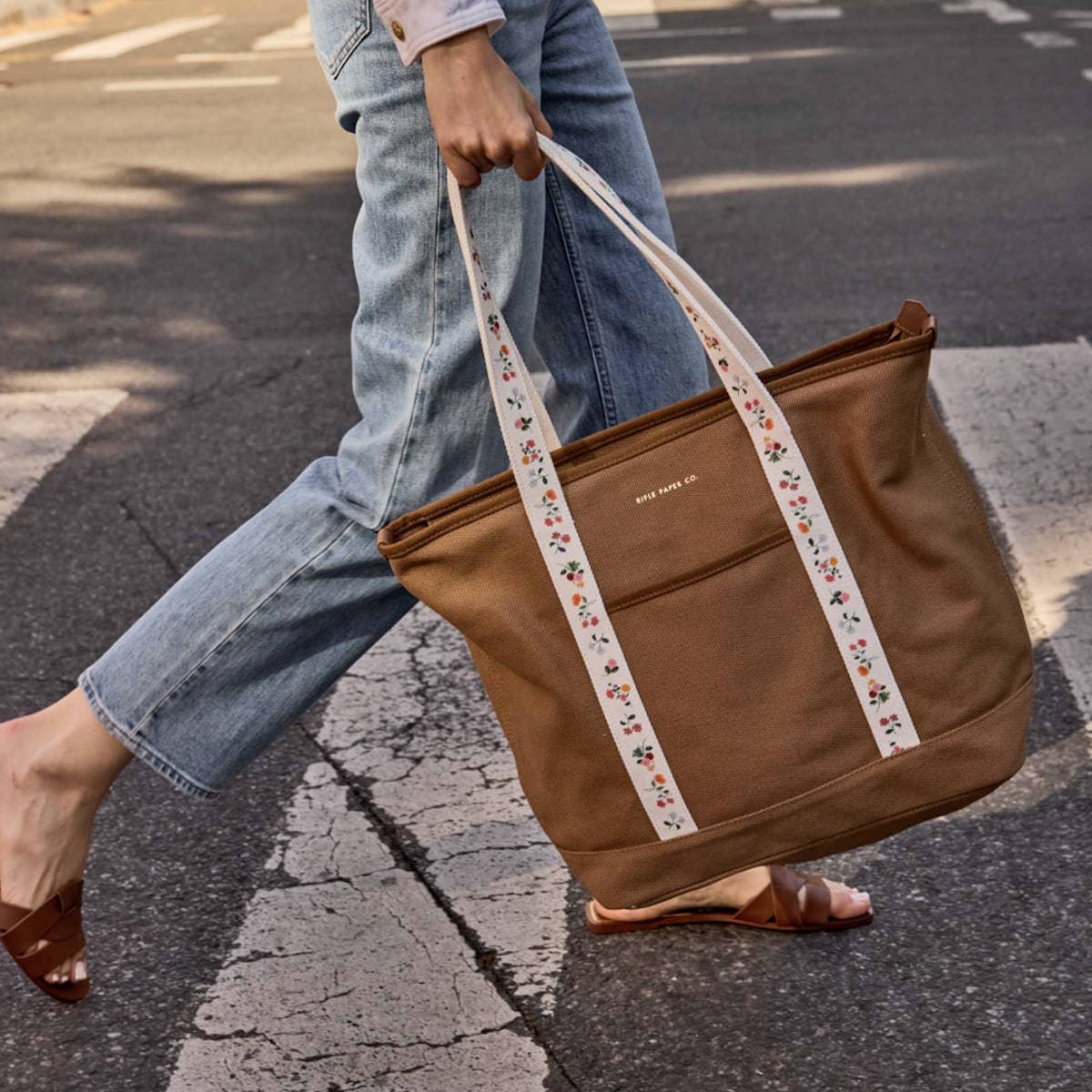 Rifle Paper Co. Ditsy Dahlia Canvas Carry All (1 pc) - product shown with model walking outside. 