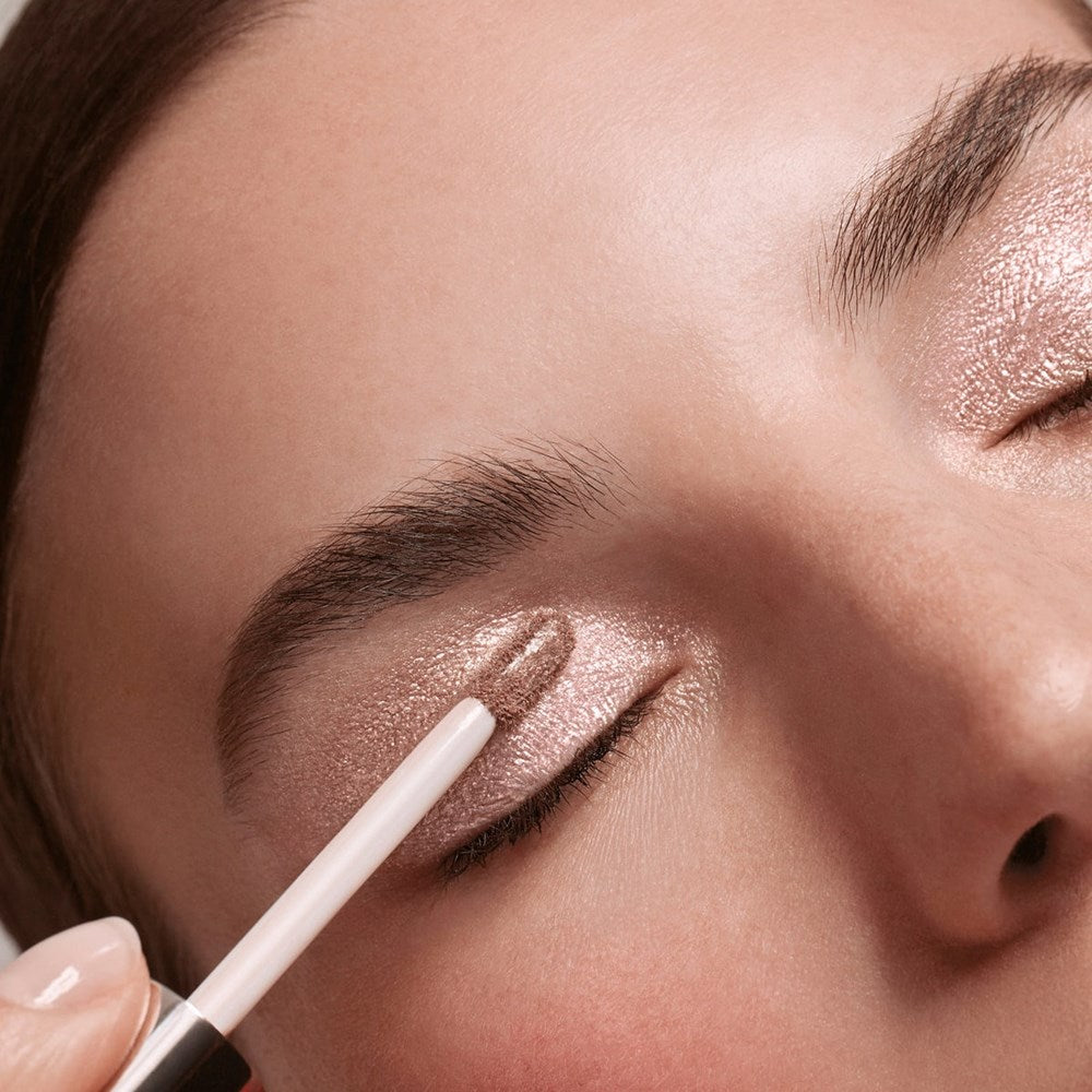 Chantecaille Eye Lumiere Liquid Eyeshadow – Cremant (4 ml) - model shown applying products. 