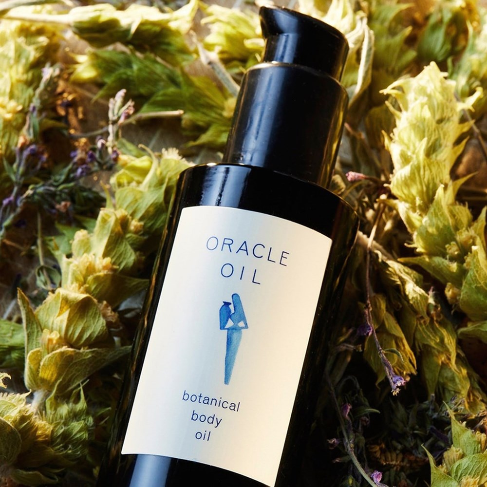 Oracle Oil Botanical Body Oil (100 ml) - product shown on greens. 