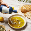 Oracle Oil Olive Oil (500 ml) - product shown being poured into a bowl with other ingredients (ingredients not included).
