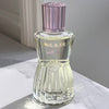 Paul & Joe Beaute Firming Body Oil (80 ml) - product shown on marble counters. 