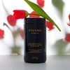 Figaro Apothecary Lush Botanical + Floating Mineral Bath Soak (16 oz) with red tulips in the background