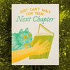 Bromstad Printing Co. Next Chapter Greeting Card (1 pc) - product shown on green sparkly tinsel. 