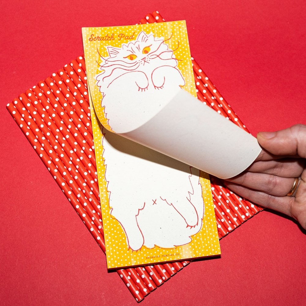 Bromstad Printing Co. Scratch Pad (1 pc)- product shown on polka-dotted red background. 