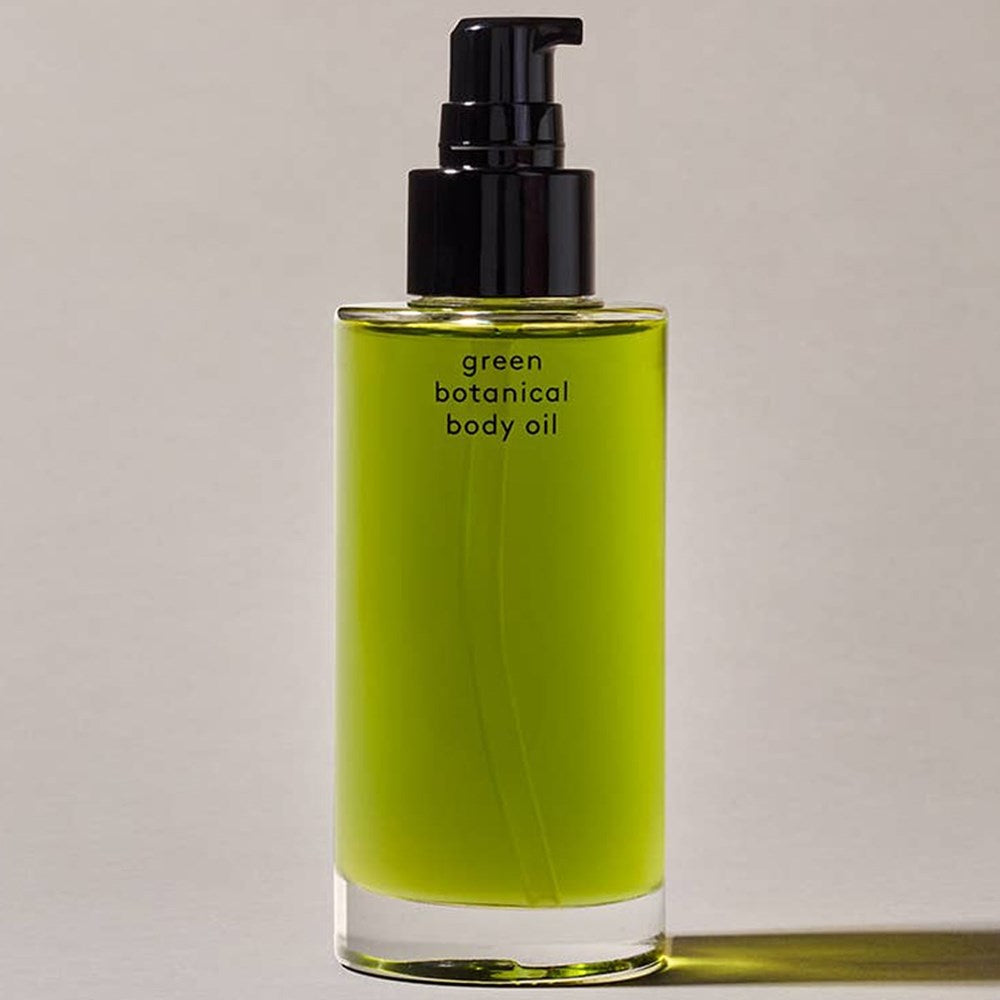 Activist A.M.S. Green Botanical Body Oil (3.4 oz) - product shown with cap removed. 