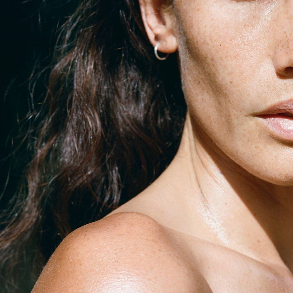 Activist A.M.S. Green Botanical Body Oil (3.4 oz) - product shown applied on models skin.