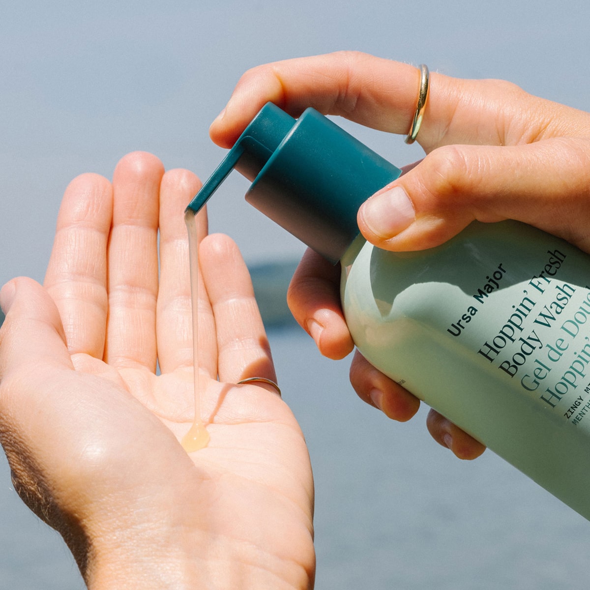 Model pumping Ursa Major Hoppin’ Fresh Body Wash (10 oz) on to palm