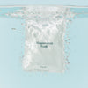 Mother Mother Magnesium Bath Soak – Single Soak (3 oz) - product shown in packaging under water. 