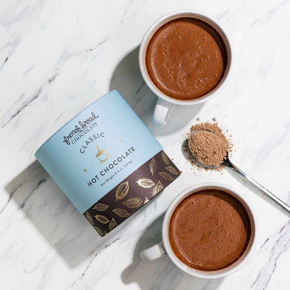 French Broad Chocolate Classic Dark Hot Chocolate (8 oz) - product shown next to mugs with hot chocolate in them.