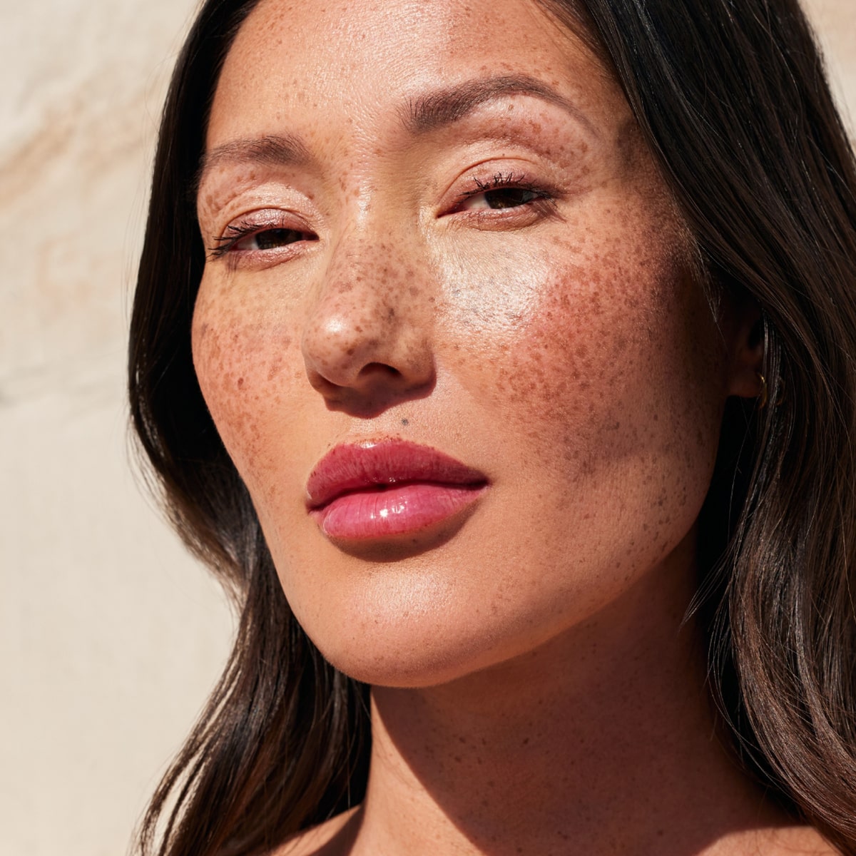 Cote The Necessity Peptide Lip Shine - Lola (3.5 ml) - product shown on model. 