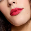 Cote The Necessity Peptide Lip Shine - Tempted (3.5 ml) - product shown on model.