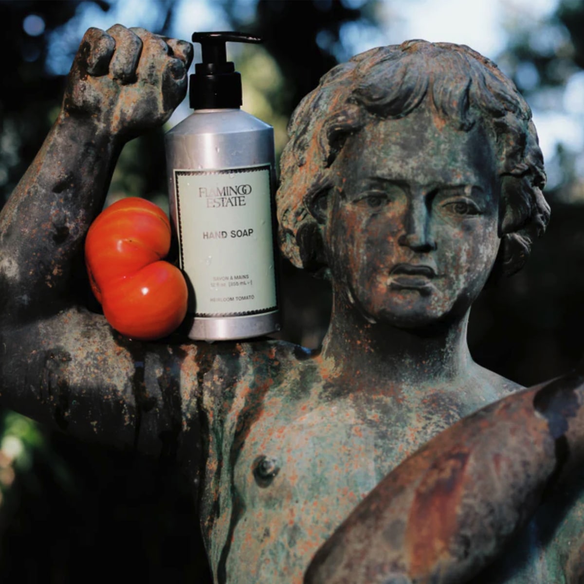 Flamingo Estate Organics Heirloom Tomato Hand Soap (355 ml) - product shown on old statue. 