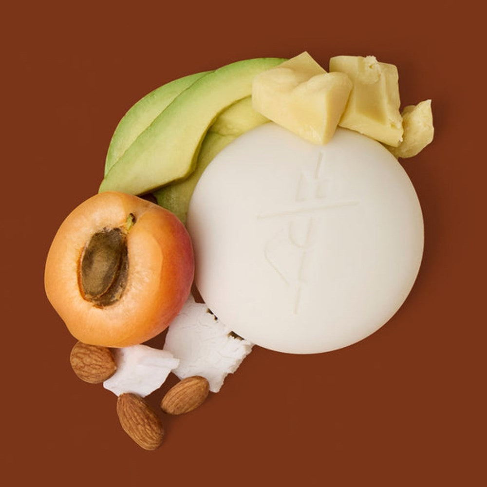 Kate McLeod Black Spruce & Patchouli Deep Moisturizing Lotion Bar (3.5 oz) - product shown with fruits and nuts. 