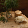 Kate McLeod Black Spruce & Patchouli Deep Moisturizing Lotion Bar (3.5 oz) - product shown on wooden table with a cloth. 