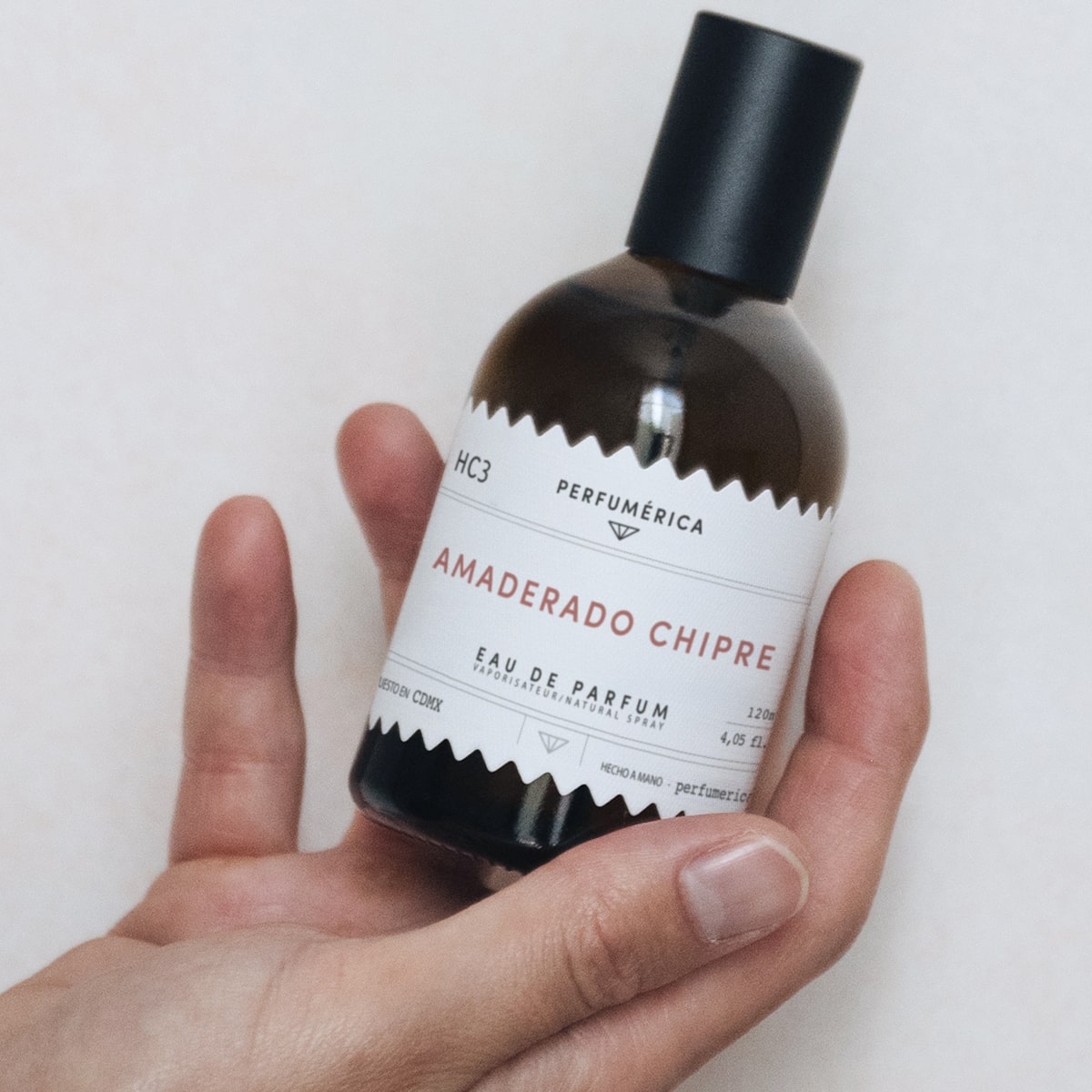 Perfumerica Amaderado Chipre Eau de Parfum (120 ml) - product being held. 