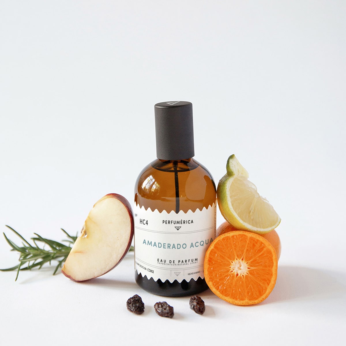 Perfumerica Amaderado Acqua Eau de Parfum (120 ml) - product next to fruit. 