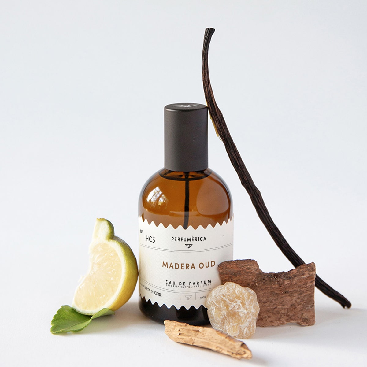Perfumerica Madera Oud Eau de Parfum (120 ml) - product shown next to fruit and salt. 