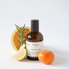 Perfumerica Bergamota Eau de Parfum (120 ml) - product shown next to citrus. 