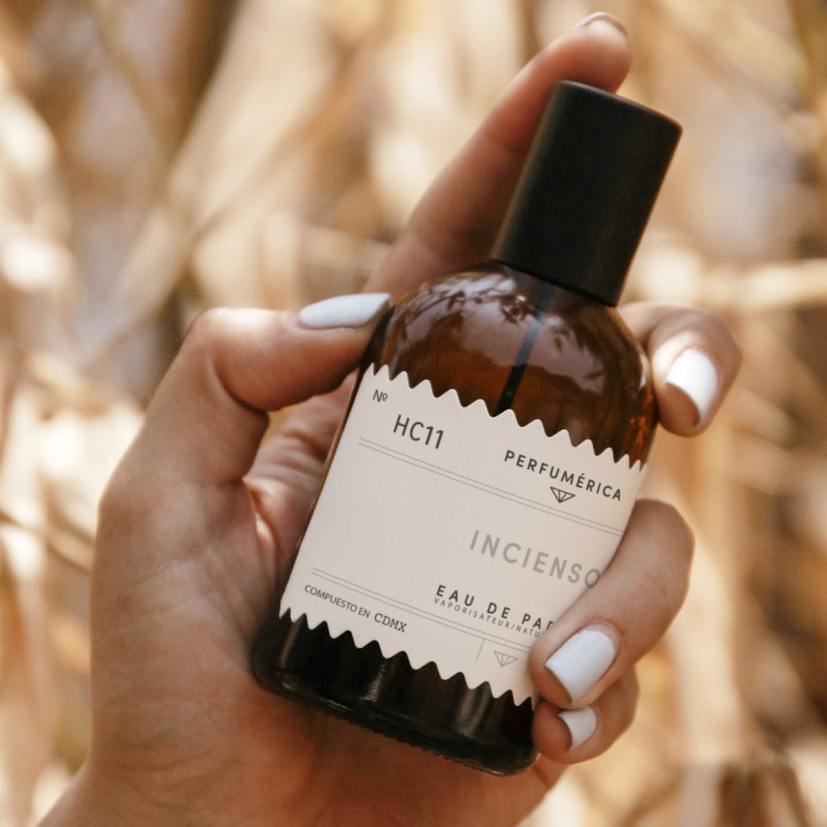 Perfumerica Incienso Eau de Parfum (120 ml) - product shown being held by hand. 