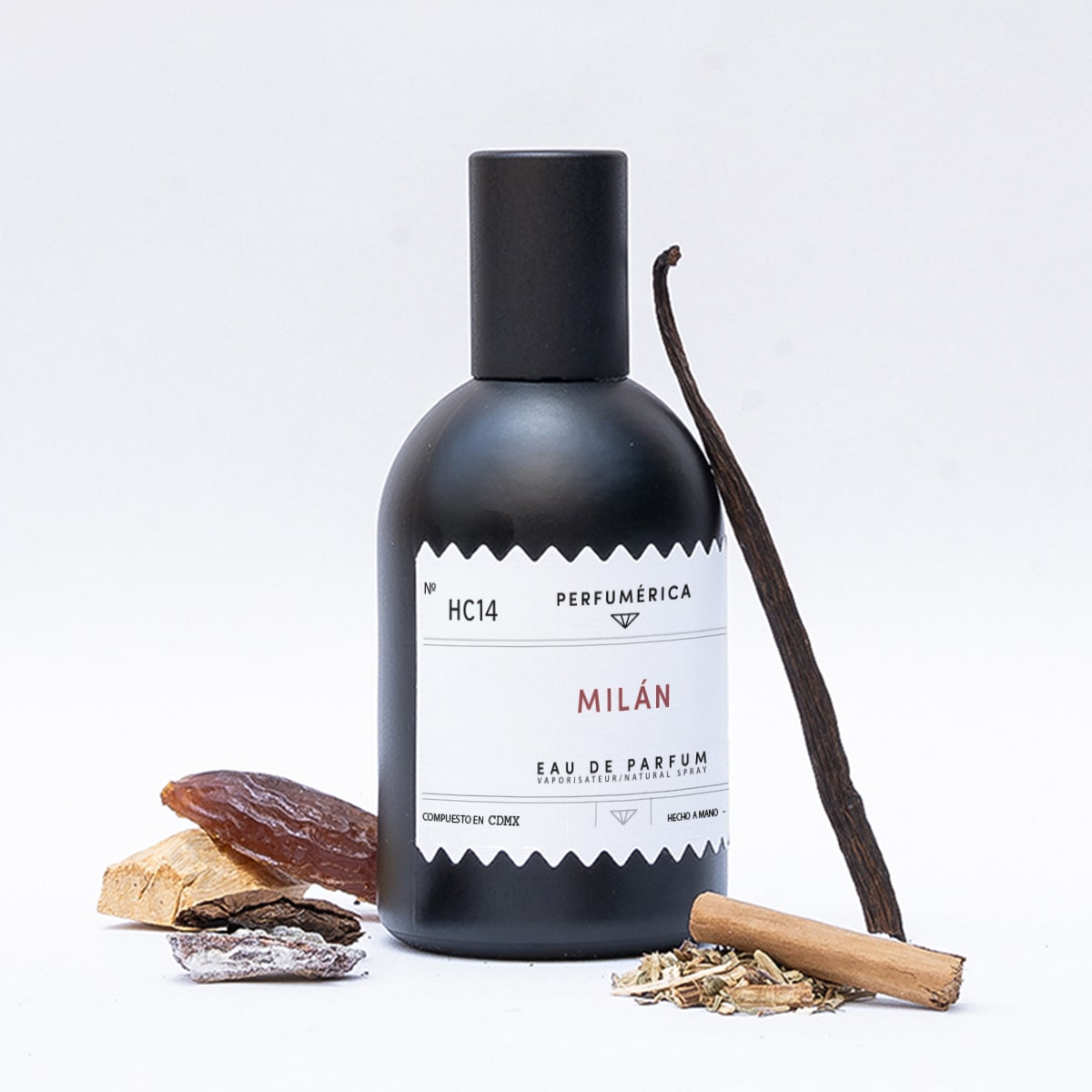 Perfumerica Milan Eau de Parfum (120 ml) - product shown next to vanilla and wood. 