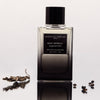 Essential Perfumes Bois Imperial Collector Edition by Quentin Bisch (100 ml) on a reflective surface with dried leaves and berries.