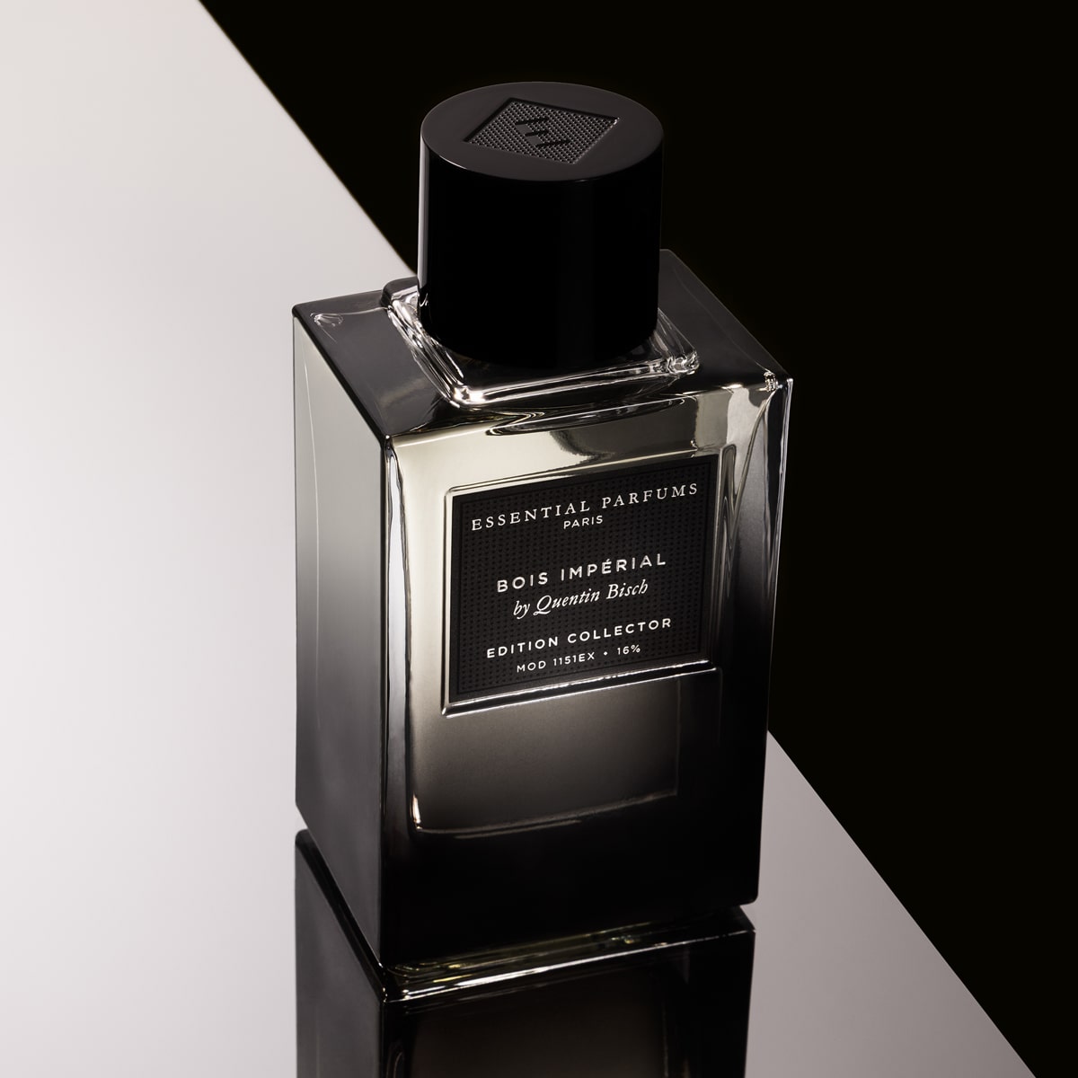 Essential Perfumes Bois Imperial Collector Edition by Quentin Bisch (100 ml) on a reflective surface with a black and white background.
