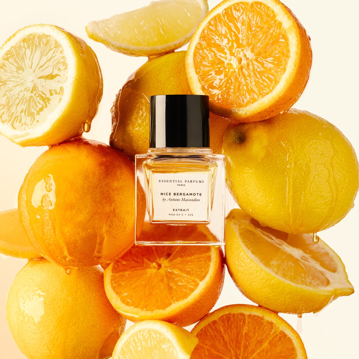 Essential Perfumes Nice Bergamote Extrait de Parfum by Antoine Maisondieu (50 ml) surrounded by lemons and oranges on a beige background