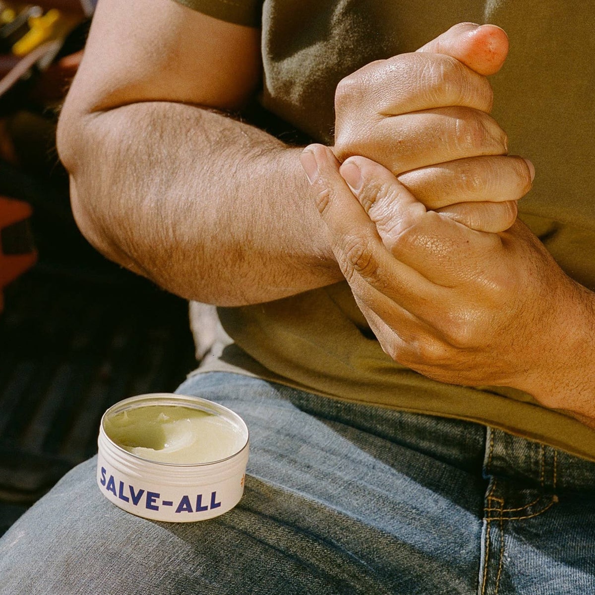 Dr. Max’s Salve-All (3.3 oz) - product shown being applied to hands. 