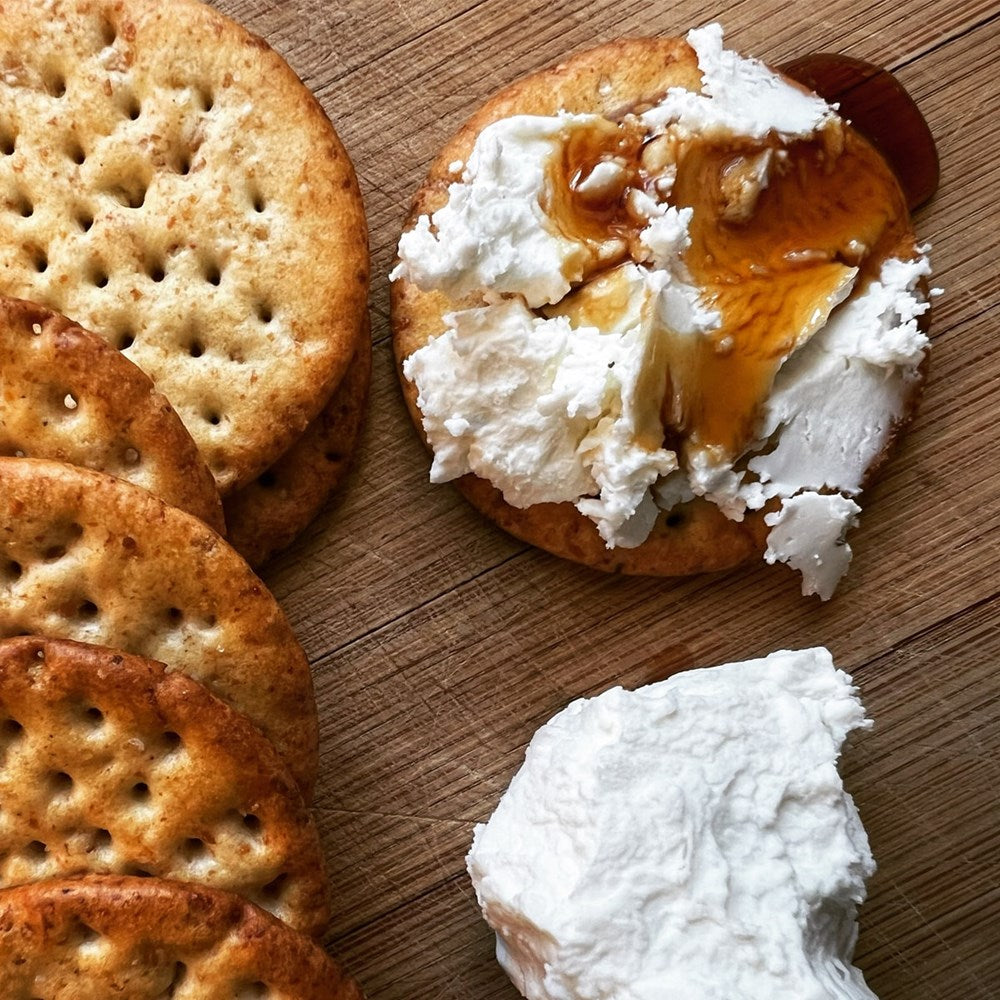 Pen & Cob Farm Spruce Syrup (5 oz) - cracker shown with cheese and syrup.