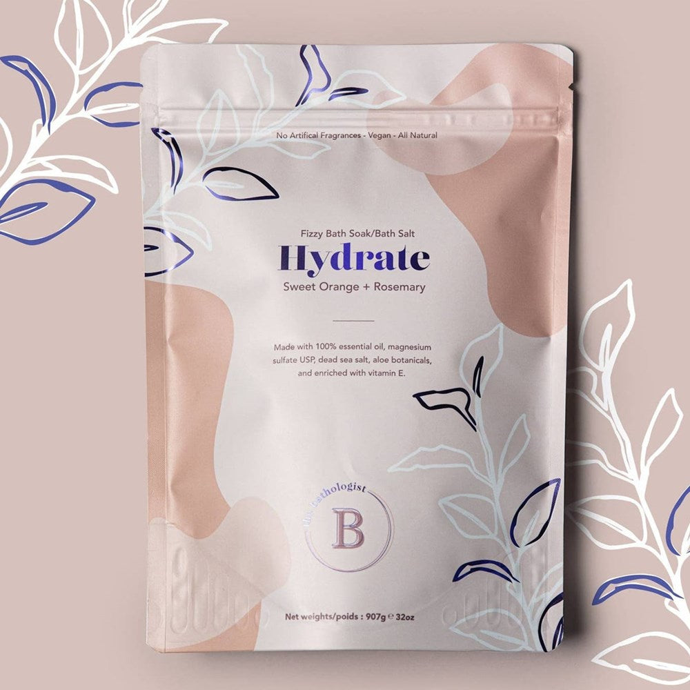 The Bathologist Hydrate Fizzy Bath Soak (907 g) - product shown on pink background.