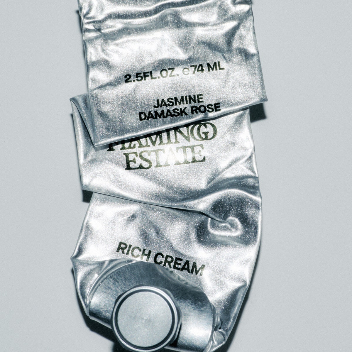 Flamingo Estate Organics Jasmine Damask Rose Rich Cream (74 ml) - product container shown empty and flat.